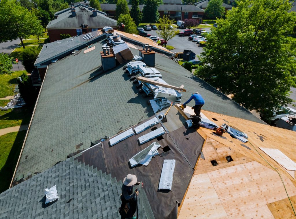 Construction worker on a renovation roof the house installed new shingles